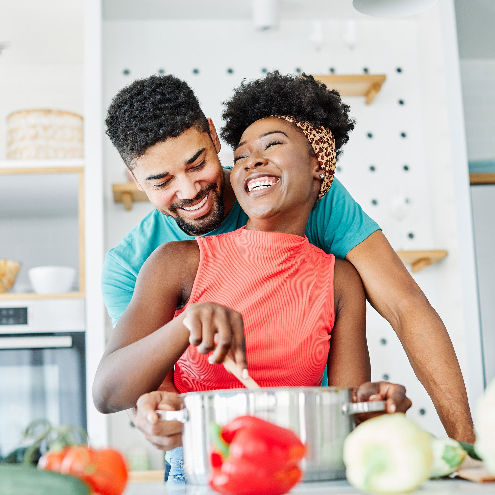 Happy couple cooking together in a kitchen