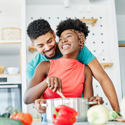 Happy couple cooking together in a kitchen