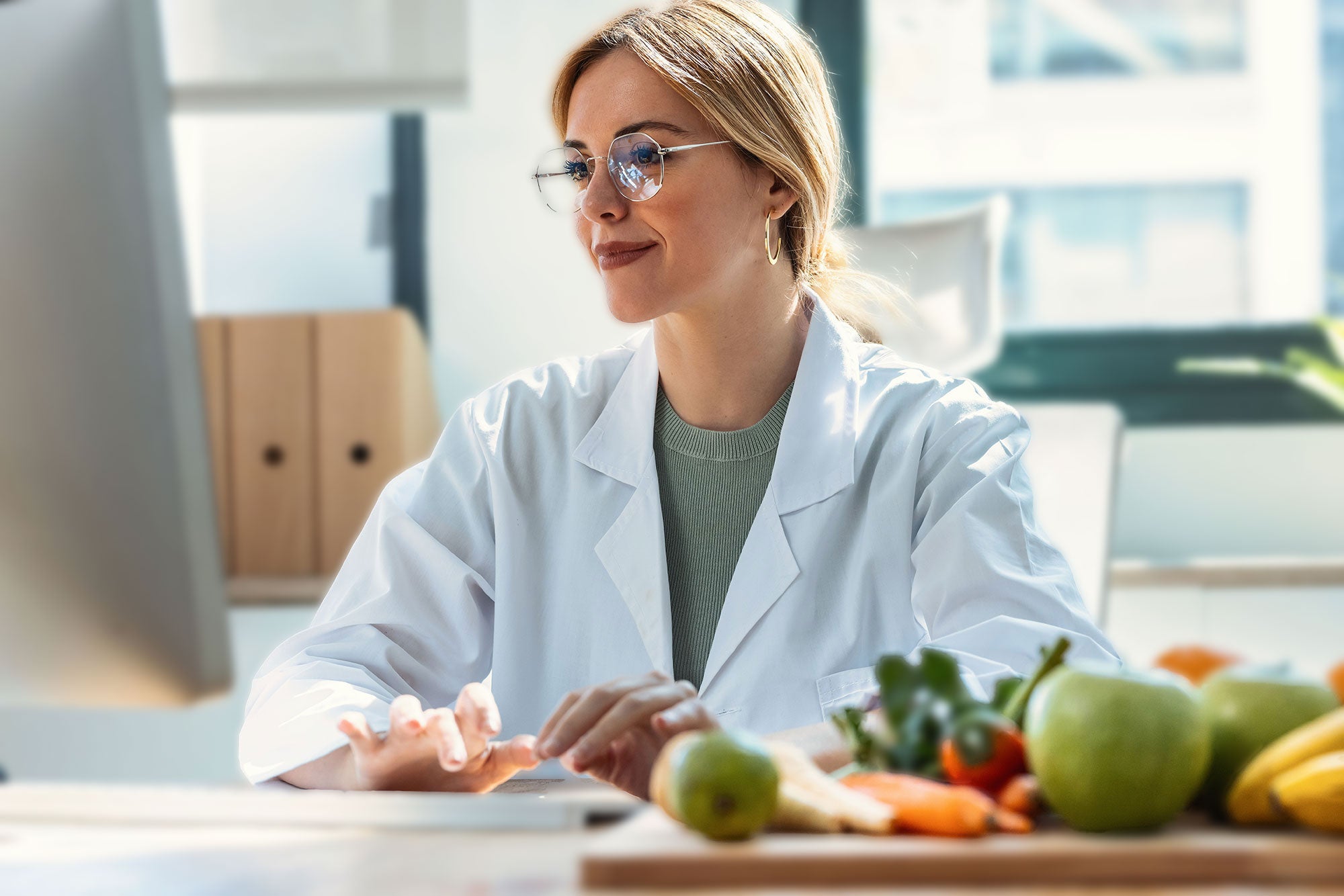 Scientist in a lab coat with vegetables on a table