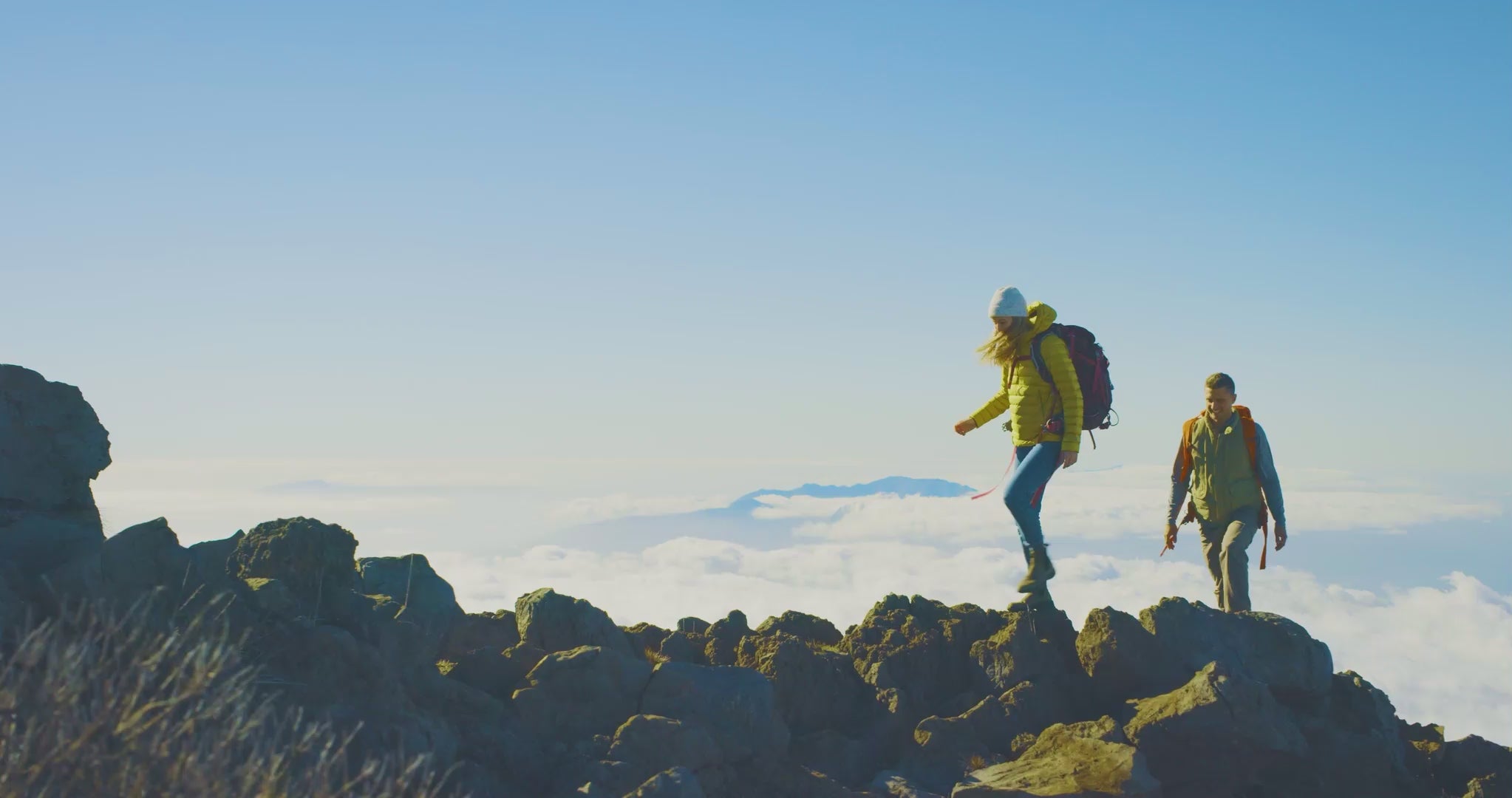 Load video: Backpackers on top of a mountain range.
