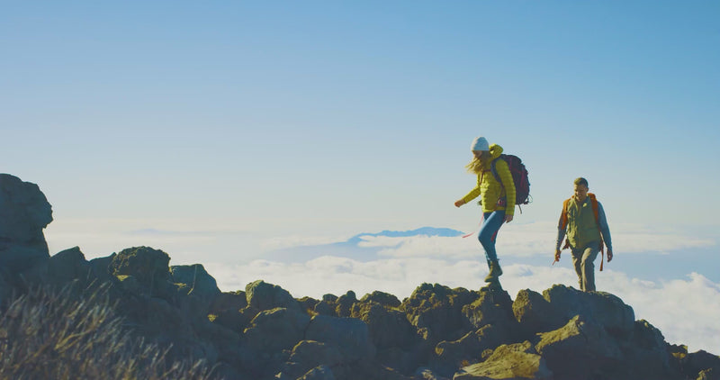 Backpackers on top of a mountain range.